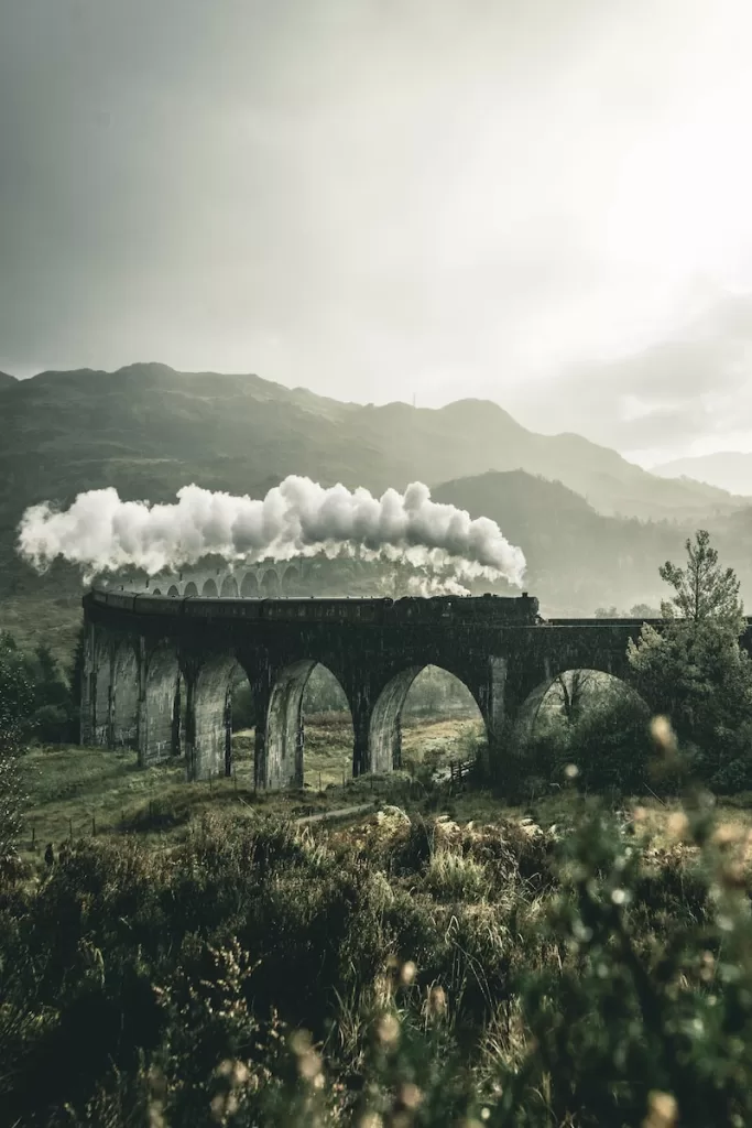 black train on railway bridge, Caledonian Travel