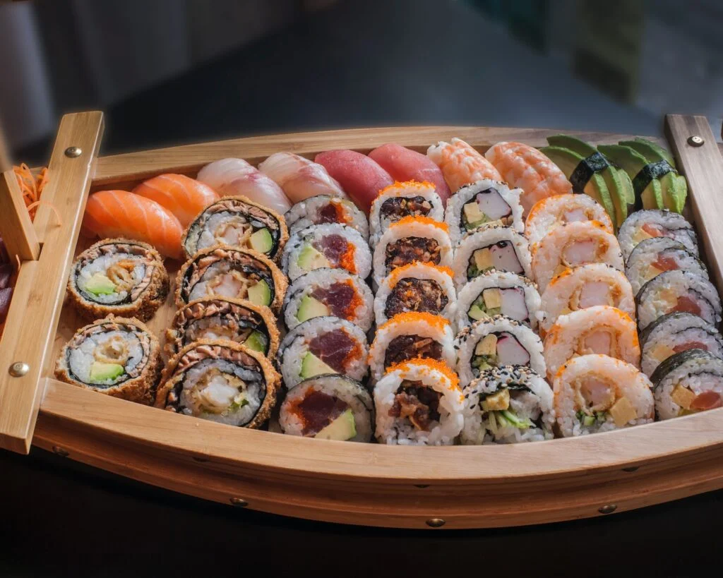 boat plate with varieties of sushi, nigiri sushi, maki sushi